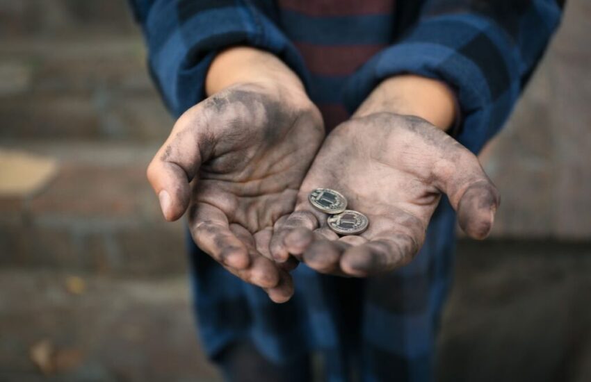 A poor widow holding two small coins.