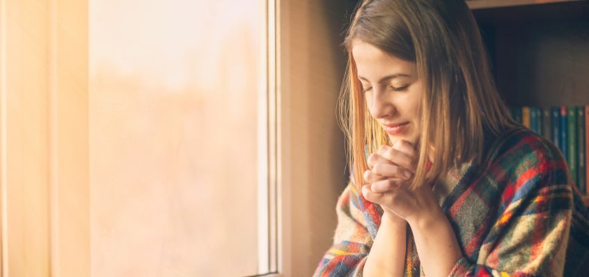 The woman is praying solemnly every friday.