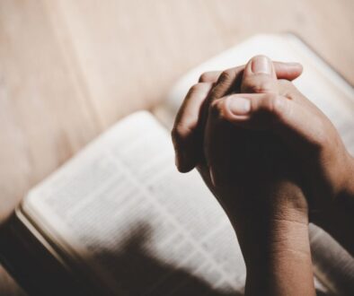 The man prays after reading gospel verses in the bible.