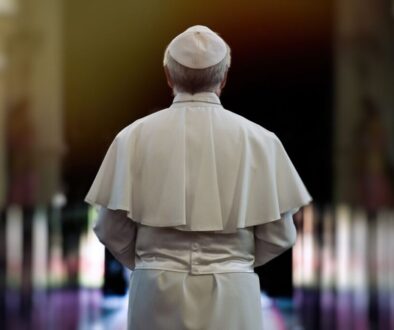 The pope walks through a church.