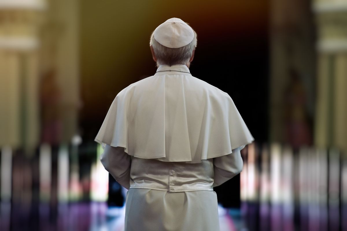 The pope walks through a church.