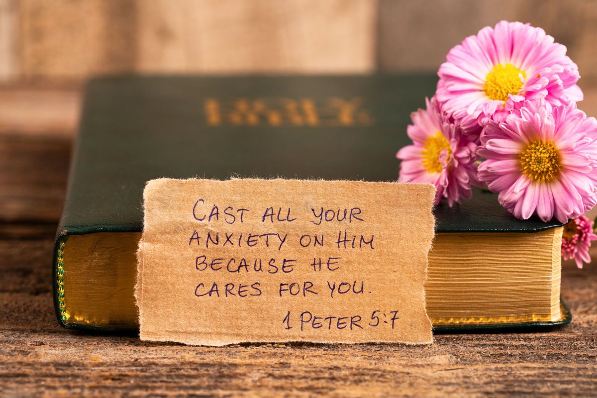 Holy Bible with handwritten 1 Peter 5:7 verse and flowers, a beautiful reminder for bible verse Sunday