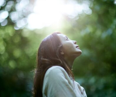 A woman practicing contemplative techniques like silent prayer in a peaceful environment.