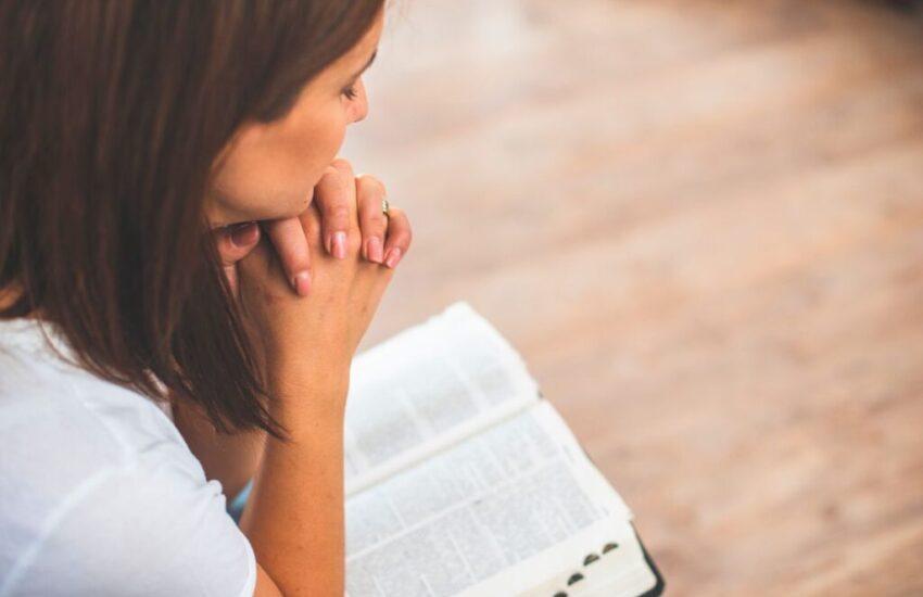 being a woman of god bible verses (3) The woman prays after reading a Bible verse.