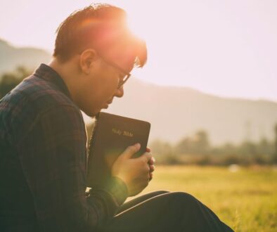 The man is praying solemnly.