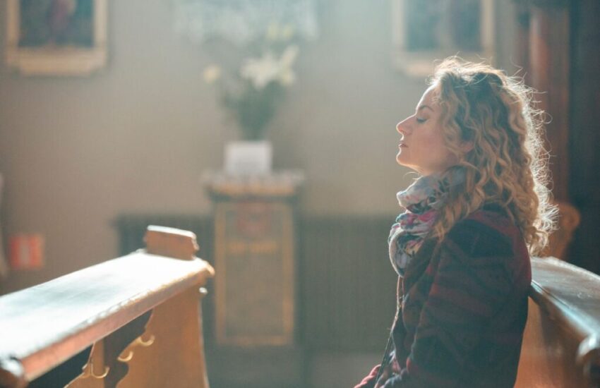 A woman praying in church.