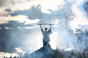 Moses holds up his staff.