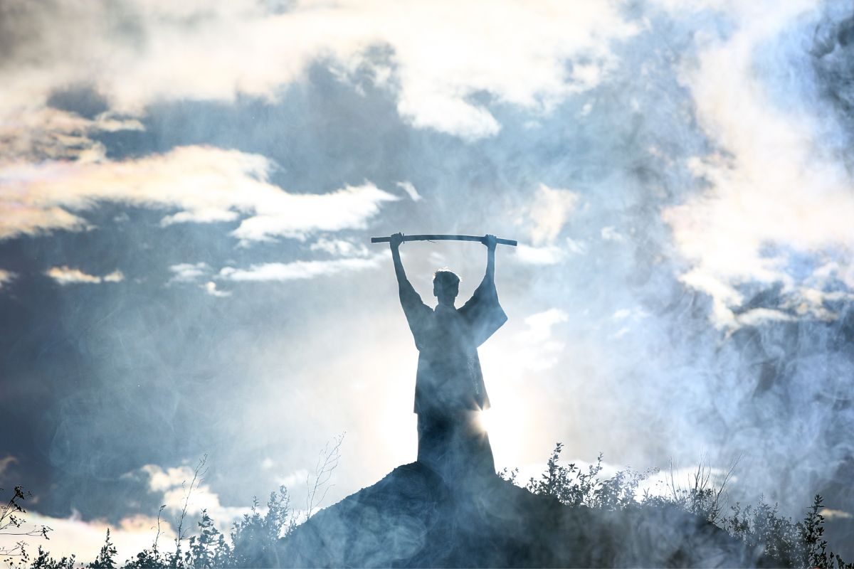 Moses holds up his staff.