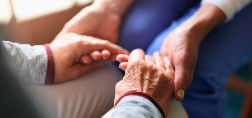 Close-up of hands offering comfort and support, reflecting the message of kindness and empathy found in Bible verses.