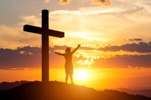 A Christian is cheering at the top of Mount Calvary.