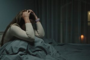 A woman awake at night, suffering from depression.