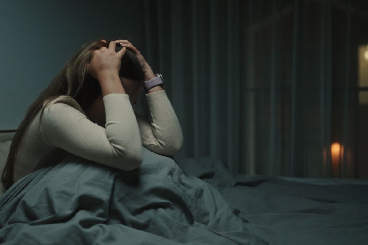 A woman awake at night, suffering from depression.