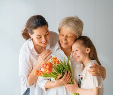 Three generations of women sharing a loving embrace, representing bible verses for mothers