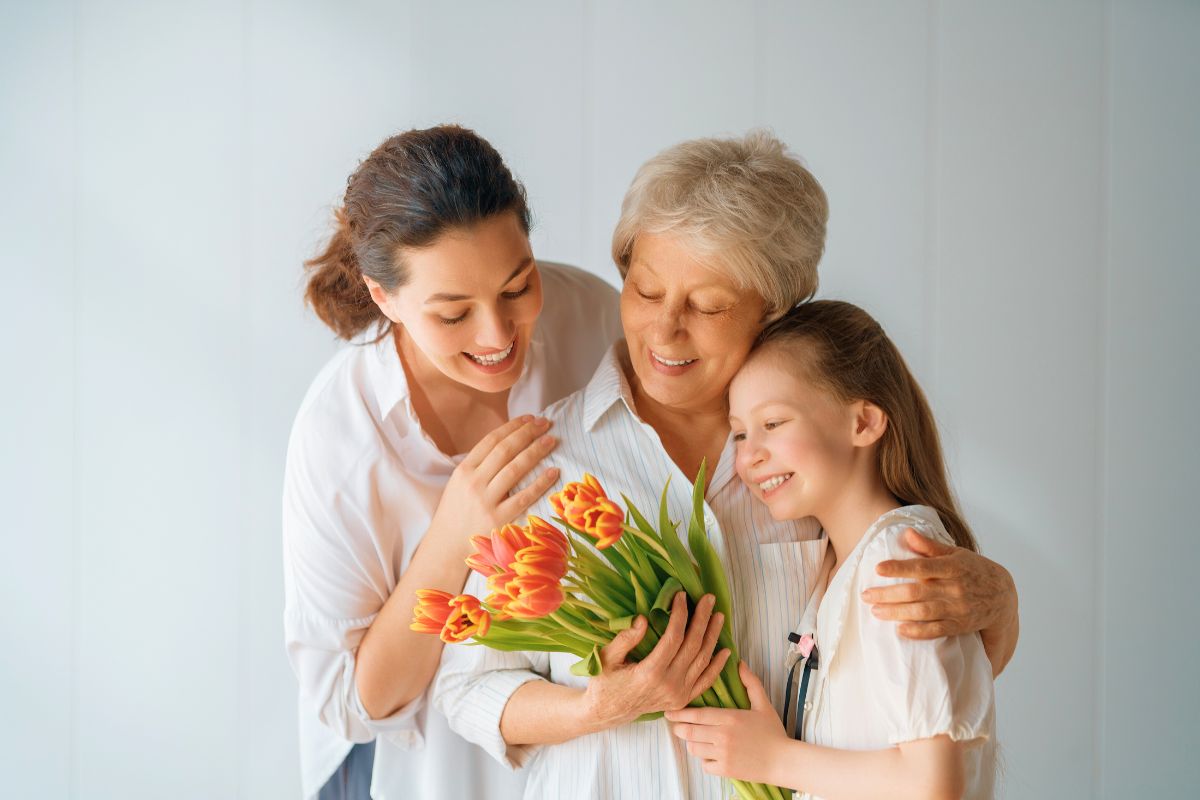 Three generations of women sharing a loving embrace, representing bible verses for mothers