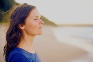The woman felt peace and prosperity while standing in front of the sea.