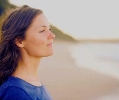 The woman felt peace and prosperity while standing in front of the sea.