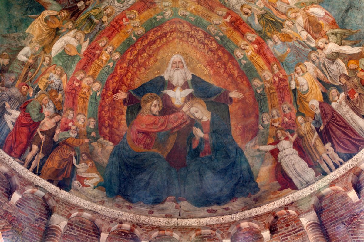 The Holy Trinity of Father, Son, and Holy Spirit is painted on a church ceiling.