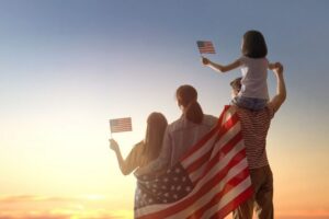 A patriotic family waves the American flag.