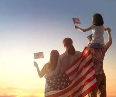 A patriotic family waves the American flag.