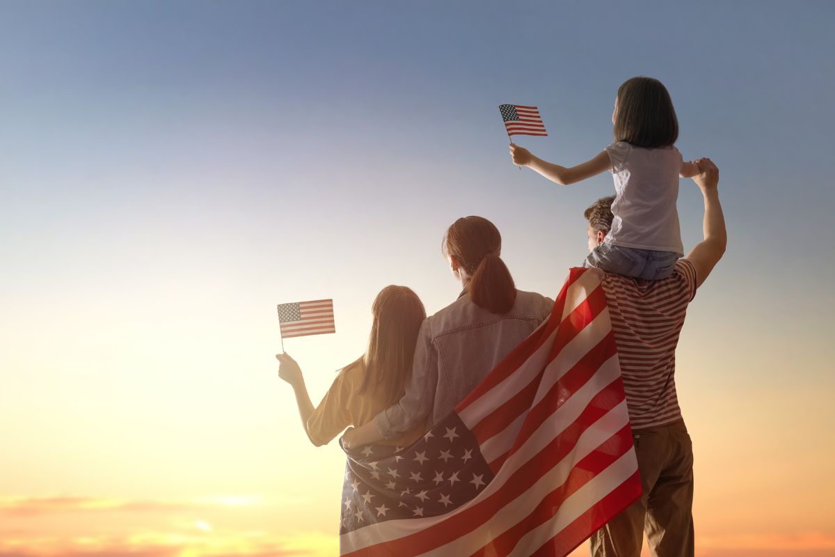 A patriotic family waves the American flag.