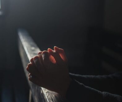 A man praying silently in a Catholic Church.