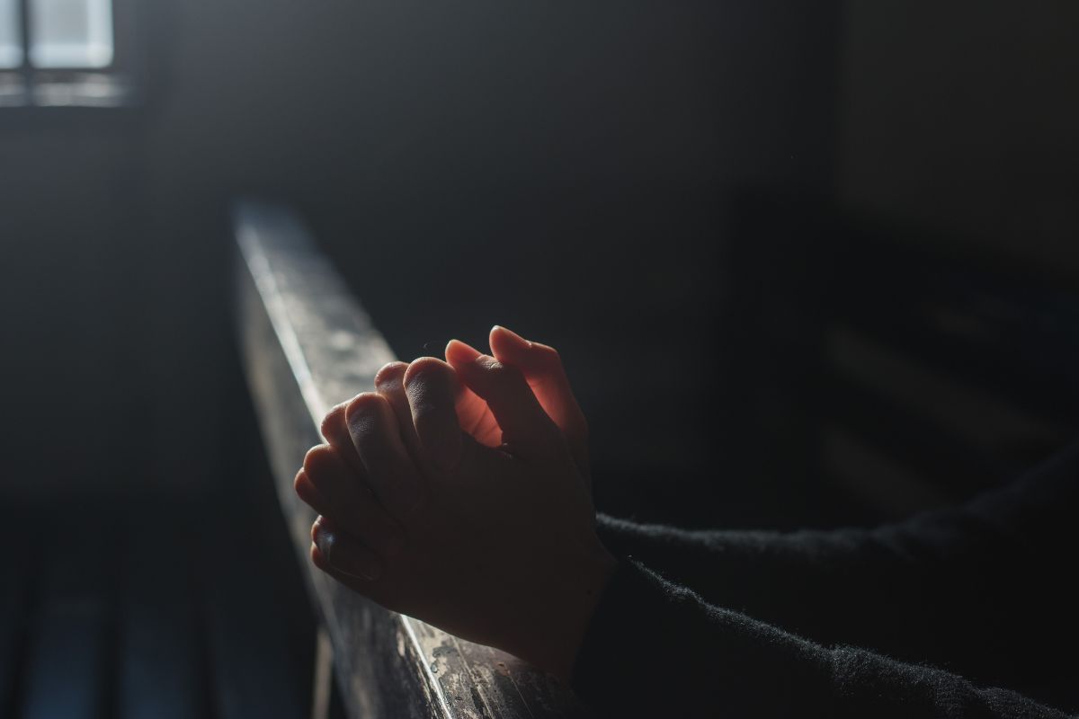 A man praying silently in a Catholic Church.