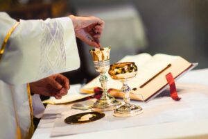 The priest prepared communion on the altar.